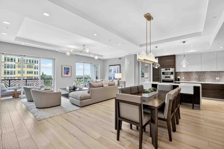 Step into the epitome of modern luxury with Unit 611 at Tower 155, located in the heart of vibrant downtown Boca Raton. This expansive 2,308-square-foot residence seamlessly blends sophistication, comfort, and cutting-edge technology, offering 3 bedrooms, 3 bathrooms, and a dedicated office space. The heart of the home, a chef's dream kitchen, features upgrades such as dual dishwashers, dual sinks, a warming drawer, and a quartz island that's as functional as it is stylish. The dining area boasts a custom-built bar with a wine refrigerator, perfect for entertaining, while the living room is enhanced by a custom TV unit and designer finishes throughout. Thoughtful touches like the built-in desk and shelving in the office, conveniently located adjacent to the primary suite, make this     space as practical as it space as practical as it is beautiful.  The primary suite is a tranquil retreat, complete with electronic blinds, his-and-hers custom-built closets, and a spa-like bathroom featuring a glass-enclosed shower and a soaking tub. The layout includes two spacious guest suites, and two bathroom, ensuring privacy and comfort for family or visitors. Designer elements, including exquisite wallpapers and stunning light fixtures, elevate every corner of this residence.  This home is equipped with state-of-the-art technology, including perimeter LED lighting, a fully integrated Sonos sound system, Savant smart home controls for lighting, Nest climate control, and a fingerprint entry lock system for ultimate security and ease. Step outside to enjoy an expanded balcony, ideal for taking in the fresh Florida air. Additional conveniences include a walk-in laundry room with a sink, extra refrigerator, and ample storage, as well as two assigned parking spaces and a private storage closet.  All of this is located within the prestigious Tower 155, offering a prime downtown Boca Raton lifestyle with unparalleled access to dining, shopping, and entertainment. Don't miss the chance to call this extraordinary residence home.