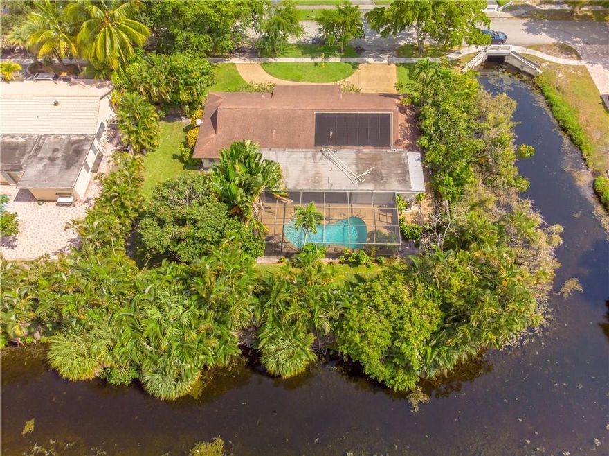 Great location in Plantation!! No Homeowners association for this 3 bedroom 2 and a half bath 2 car garage screened in pool home on over a quarter acre surrounded by water on 2 sides. Already have half a moat!!! Large outside covered area by the pool. Great for entertaining. Family room has built in wet bar. RENT INCLUDES LAWN AND POOL MAINTENANCE!!