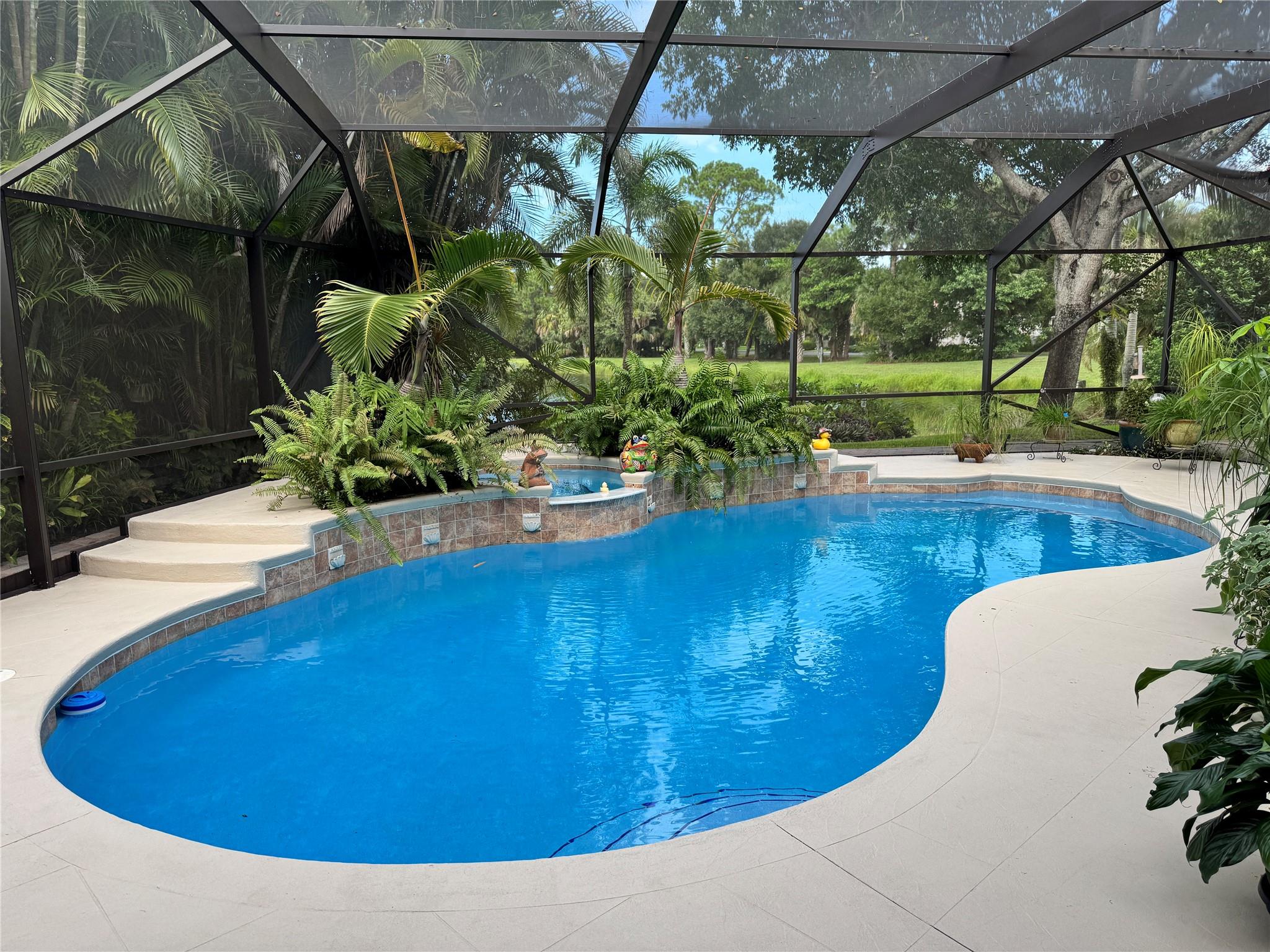 3,100 sq. ft. home features 4BED+Office, 3BA and a second story bonus room! Add to that a separate living room, family room and dining room and you have a house your whole family can enjoy. A large private screened lanai and 2024 resurfacing of the sparkling in-ground pool w/spa and waterfall overlooks a tranquil pond, creating an ideal setting for relaxation and entertaining. The paver circular driveway and 2-car garage offers plenty of parking space. Additional upgrades include whole house re-piping, porcelain wood-look tile flooring, two newer AC units, and accordion hurricane shutters.