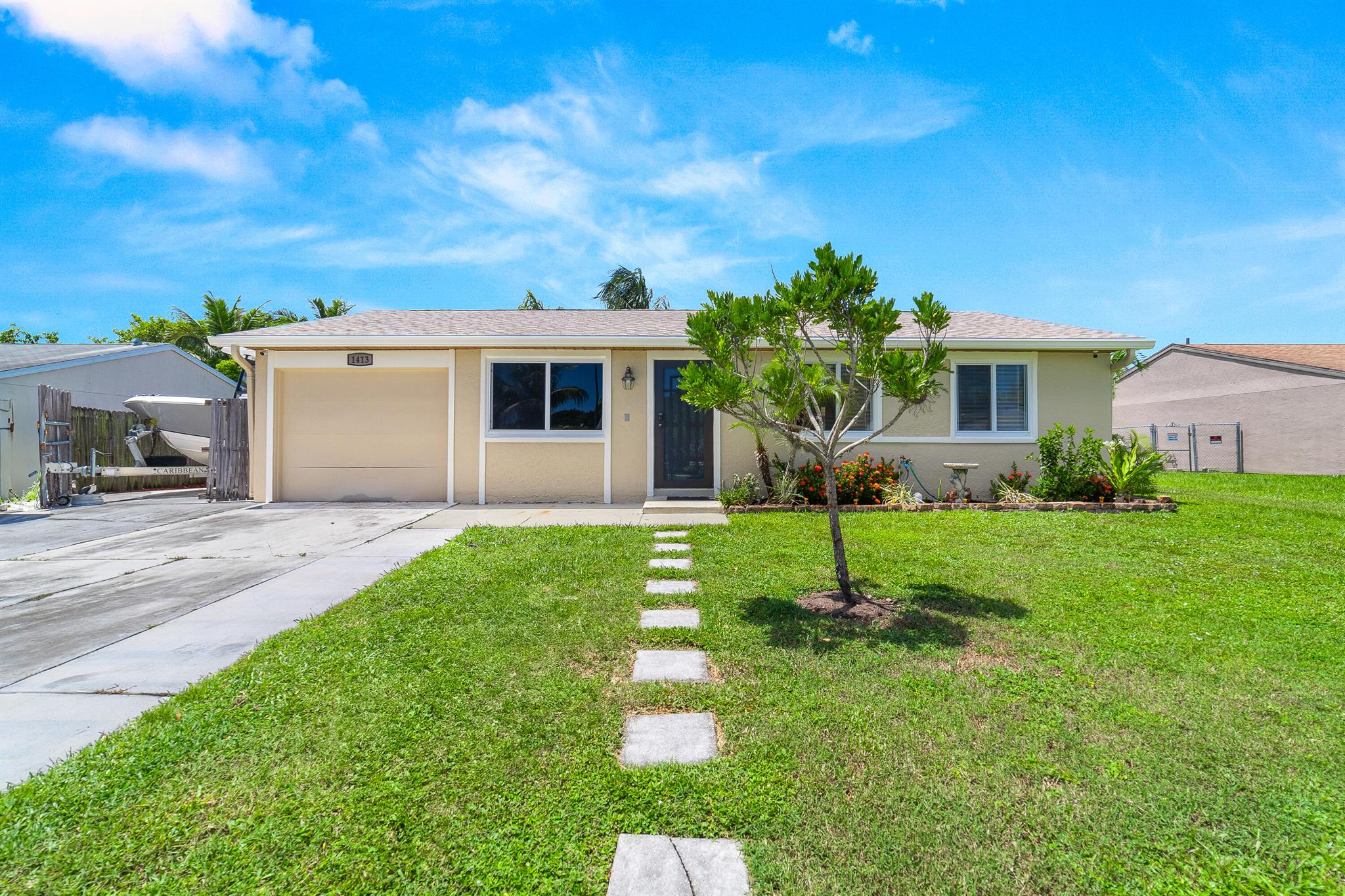 Welcome to this 3-bedroom, 2-bathroom single-family home on an oversized lot with no HOA fees or restrictions. Featuring a new roof (2025), impact glass windows and doors, freshly painted interior, A/C (2024), and water heater (2019), this home is move-in ready. Tile flooring throughout. The kitchen includes stainless steel appliances, and the open layout extends to a covered and screened patio with room for a pool. The garage has been converted, offering flexible use of space, while the fenced backyard includes a shed for extra storage. With parking for two vehicles, ample space for a boat, RV, or trailers, and a prime location near Breakers West Country Club, parks, shopping, and dining--this property is a rare find. Mortgage savings may be available for buyers of this listing.