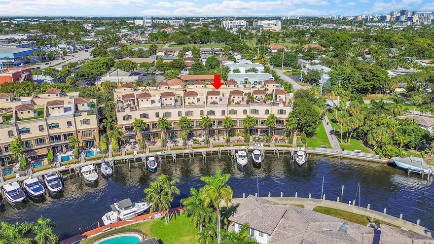 Stunning, recently updated, furnished 4-story luxury townhome with widewater views of Lake Santa Barbara,  dock and assigned boat slip. Direct ocean access--no fixed bridges, minutes to Hillsboro Inlet. Private elevator to all levels, high ceilings, marble and hardwood floors. Gourmet kitchen with quartz countertops, GE Monogram appliances, oversized cook-top island. First floor includes a 2-car garage, foyer, half bath, large living area, office/exercise room/4th BR, walk-out kitchen overlooking the patio and dock. Second floor offers spacious kitchen, dining and living areas, laundry room/pantry, and half bath. Third floor hosts the primary suite with kitchenette, two bedrooms with walk-in closets and a large full bath. Expansive rooftop terrace provides amazing water/city vistas.