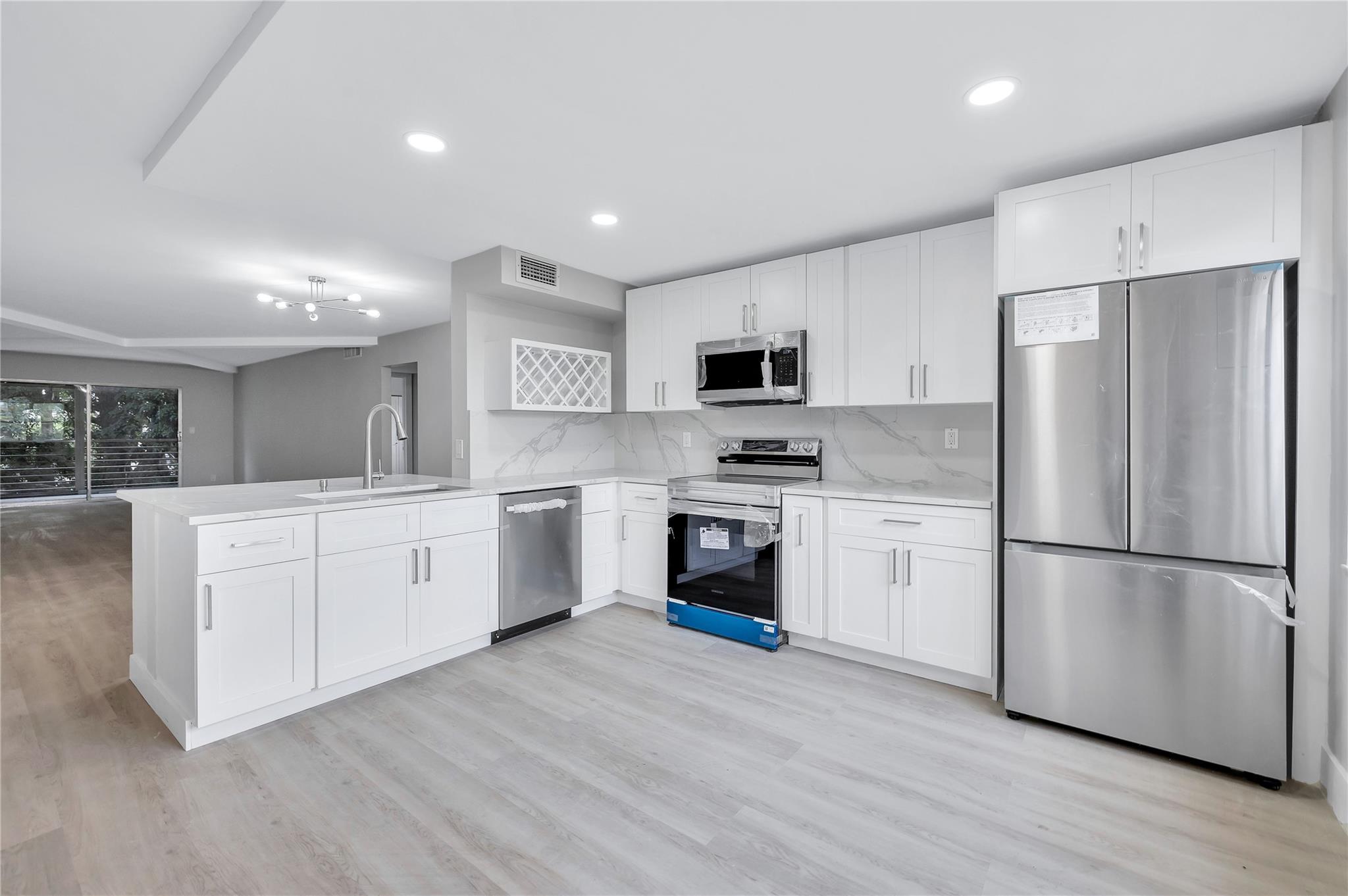 Beautifully remodeled 2/2 condo in Wynmoor. Priced to Sell! New AC, new water heater, new stainless steel appliances. The open kitchen has brand new white cabinets and quartz countertops. This stunning condo spared no expense. You’ll enjoy luxury vinyl flooring throughout the home. The bathrooms feature large format tile to ceiling, as well as new vanities & flooring. Wynmoor is a gated active adult community that offers a plethora of activities, such as pools, tennis, pickleball, theatre and much more. Seller will give credit of $1200 for washer and dryer for buyer to pick out their own.