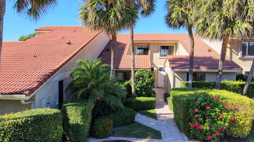 Sparkling Intracoastal views greet you upon entering this sophisticated waterfront townhouse.  Soaring ceilings and large glass sliding doors deliver plenty of natural light to the great room, kitchen, breakfast bar and dining area. Redesigned and luxuriously appointed with quality millwork, premium fixtures and exquisite stone finishes.  Gleaming white marble floors fill the living areas while a neutral palette of whites and soft coastal hues create a casual yet refined ambiance.
Upstairs lies the spacious primary suite with private balcony offering panoramic views of the lagoon and nature preserve. A detached one-car garage is adjacent to the courtyard entrance.  Nestled between the Atlantic Ocean and the Intracoastal, Ocean Cay is an upscale community offering beach access and dockage.