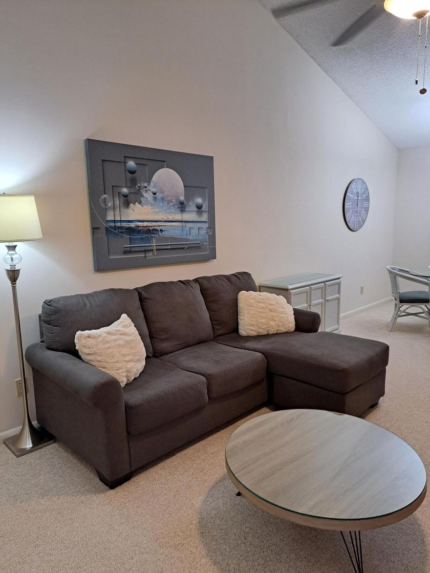 Welcome home to your fully furnished condo. Soft carpet runs throughout the main living areas, and the open-concept layout creates a light, bright feel. Enjoy modern furnishings and the screened porch overlooking your peaceful paradise.  The spacious primary suite features a queen bed, walk-in closet, and standalone shower. The kitchen is well suited for chefs of all experience levels.  Additional highlights include a newer A/C, water heater, windows, and an in-unit washer and dryer.  Community amenities include an oversized pool and picnic area, recreation room with pool and ping-pong tables, fitness room, library, community room, pickle ball and tennis ball courts...perfect for your active lifestyle