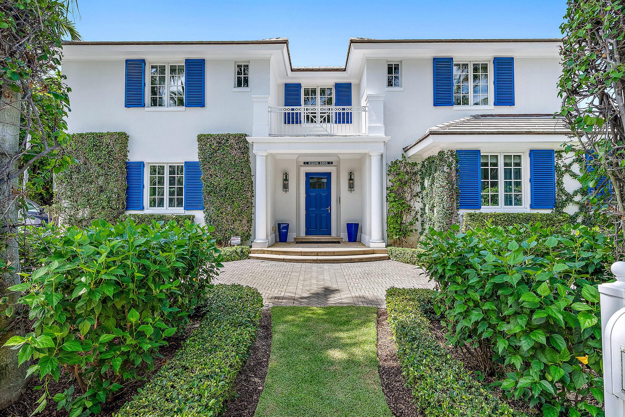 Stunning, light and bright British Colonial built in 2007 with 6 bedrooms, 7 bathrooms, and 1 powder room. Highly desirable north end gem with ocean beach access at the end of the street. Highlights include formal dining room, elevator, 2-car garage, and double height foyer and living room. Oversized gourmet chef's kitchen with top-of-the-line appliances opens to family room with beautiful built-ins. Stunning primary suite with large balcony, dual baths and walk-in closets. Spectacular outdoor spaces feature lush tropical landscaping, pool with spa, covered loggia and open patio perfect for outdoor entertaining.