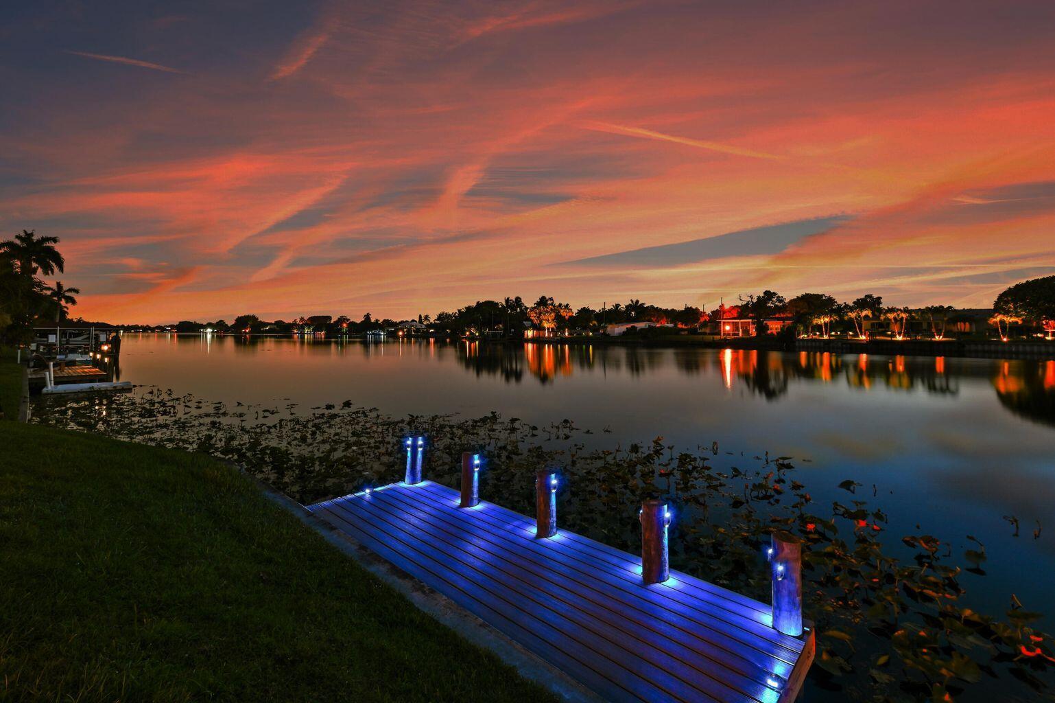Exceptional Lake Clarke Shores pool home with approximately 100 feet of lake frontage and a private dock. This well-maintained 3-bedroom, 2-bathroom residence offers over 2,070 sq. ft. of living space, a spacious kitchen, and expansive water views from the main living areas. The backyard oasis features a salt water pool, hot tub, tropical landscaping, and direct lake access for boating, paddle boarding, and fishing. Conveniently located near shopping, dining, and the beaches. Offered by ownership entity; all showings by appointment only.