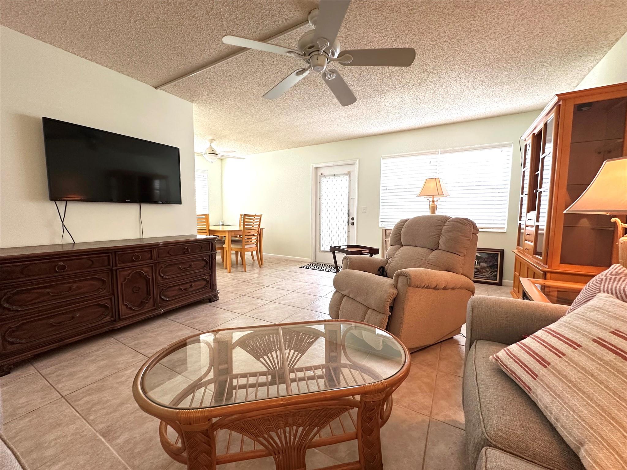 In the heart of DEERFIELD BEACH, this lovely GROUND FLR. CORNER 2 bedrm, 1.5 bath condo is PRICED TO SELL! Unit is very bright & located in the center of the community featuring lg tile flrs in liv areas & carpet in bedrms, updated shower stall w/glass doors in primary bath, freshly painted & A/C 2022.  The enclosed patio has a storage closet & overlooks a quiet garden view.  Building has a NEW ROOF!  This active adult community is gated, 24/7 security, free bus service, lavish clubhouse w/ a 1500 seat theater, state of the art gym, tennis, indoor/outdoor pools, pickleball, putting green, classes of every type, clubs, free movies, shuffleboard, billiards, library & more! Close to shopping, great restaurants, hwys & beach! Easy to show!  Don't miss this great opportunity! ASSOC. CLAIMS 55+