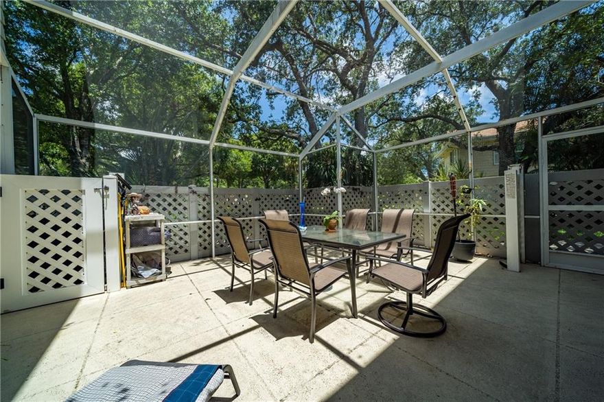 Beautiful corner townhouse unit ideally situated in the back of the community.  24 hr. manned gated community. 2 large primary suites upstairs with 1/2 bath down. A large screened-in patio offers privacy with a garden-like view in front of the home. The first floor is all tile with lots of light. Enjoy a game of tennis on the tennis courts or head out to the pool overlooking the lake. Beautiful tropical landscaping is professionally maintained. Winding sidewalks throughout this man-gated community are great for walking or a safe off-street bike ride in a garden-like setting.