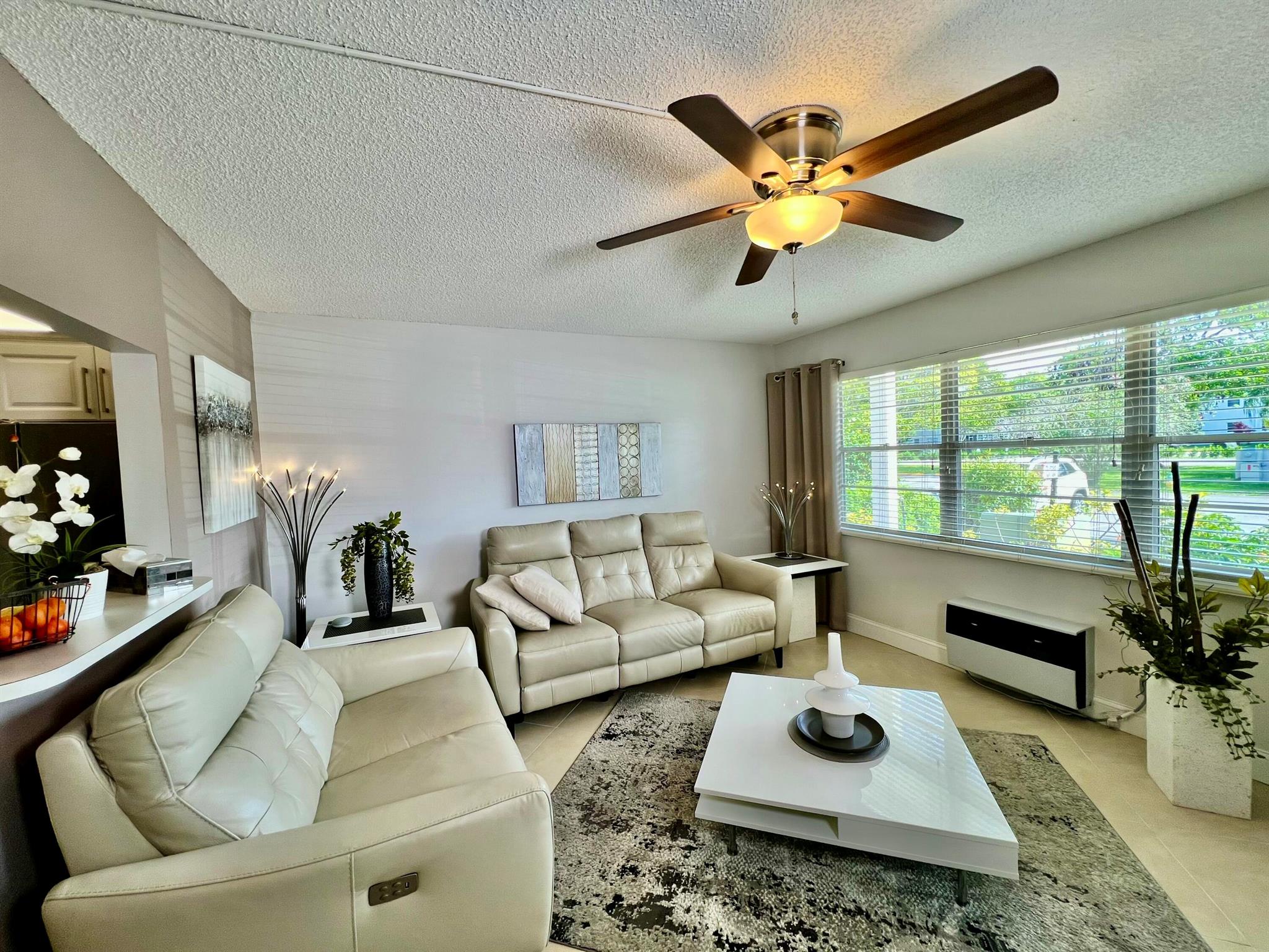 Discover modern comfort in this beautifully remodeled first-floor garden condo at Century Village East.This inviting 1-bedroom, 1.5-bath residence has been thoughtfully upgraded with a new water tank, wall A/C, and appliances--all installed in 2023.Enjoy serene lake views from the side, or step out to your private back patio, perfect for relaxing or entertaining. Offered fully furnished and turn-key, this home is rental-ready and designed for a seamless, stylish lifestyle.