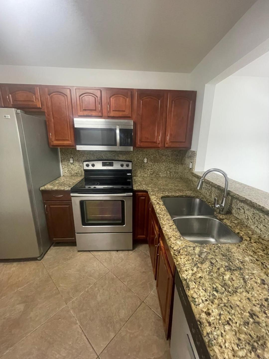 This stunning 3-bedroom, 2.5-bath townhome offers comfort, style, and convenience. Step inside to an open-concept living and dining area ideal for entertaining, featuring new laminate flooring throughout. The spacious eat-in kitchen boasts granite countertops, wood cabinetry, and stainless steel appliances. The home includes a washer and dryer for your convenience.