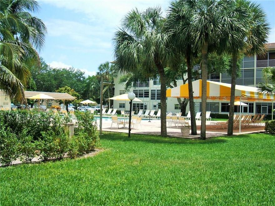 Price is Right! GROUND FLOOR with TILE ON DIAGONAL THRU-OUT and NEWER LARGE CAPACITY WASHER/DRYER INSIDE. Spacious EAT-IN Kitchen with PASS-THRU Plus NEWER STAINLESS STEEL DISHWASHER and MICRO-HOOD. Glass ENCLOSED PATIO with Closet has DOOR TO POOL. See PHOTOS Modern FURNITURE  INCLUDED (Sofa with Chaise Lounge, Lift Chair, Electric Beds). Freshly Painted. ONE OCCUPANT 55+ Information Deemed Reliable but, not Guaranteed.