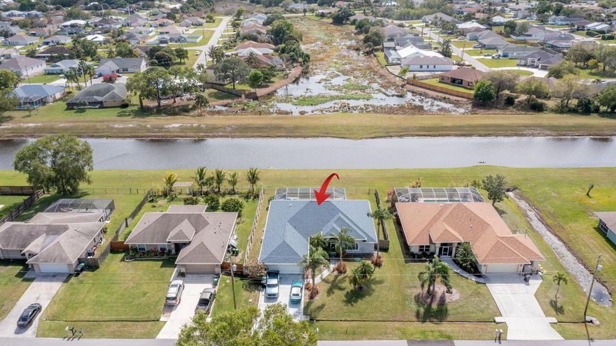 Investor opportunity! Spacious 3/2/2 with private pool and spa and large great room on a quiet street. Huge lot, fenced back yard overlooking canal. No home directly behind this one as there is a preserve on the other side of the canal. Offered well below market. It needs updating and some repairs but the roof is new (2020),  NEW HVAC 2020, gas range and the floorplan is very spacious split bedroom plan. Estimated ARV is $475k to $505k. There is a extra bonus room/office or dining room adjacent to the great room. Open bar peninsula  to the great room from the kitchen. Bedrooms 2 and 3 can be a suite with its own cabana bath. First time on the market. Oversized 462 sf garage. Huge covered and screened pool patio with built in spa. Well for sprinkler system. Come see this today.