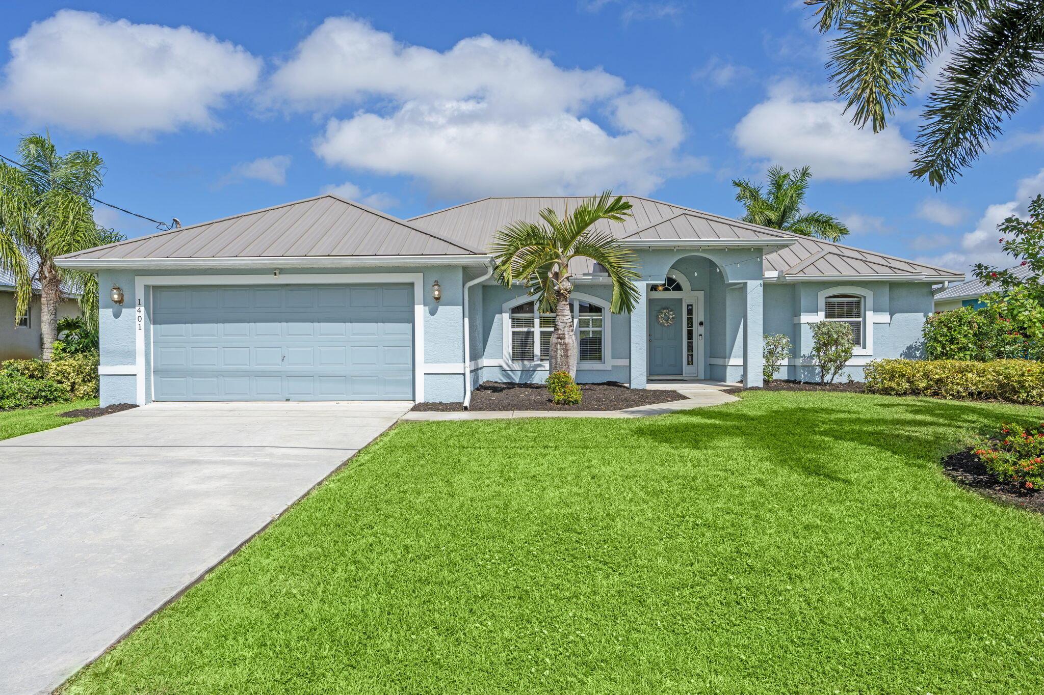 Welcome to your dream waterfront home! This beautiful 3-bedroom, 2-bath residence blends comfort, style, and true Florida living. Enjoy peace of mind with a metal roof, new AC, new water heater, and updated shut-off valves. Inside, the open floor plan, plantation shutters, and freshly painted cabinets and vanities create a bright, modern feel. Step outside to your screened-in heated pool and spacious patio with  Pocket Sliding glass doors perfect for relaxing or entertaining. The private 12'x24' dock With 12' Walkway on the C-24 canal for boating enthusiasts. 10 Minutes away from C-24 Canal Park, which offers river and ocean access. With no HOA, a generator power inlet, and a newer washer and dryer, this home has everything you need for easy, worry-free living.