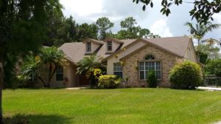 MOVE RIGHT IN TO THIS WELL MAINTAINED 3/2/2 JUPITER FARMS CBS HOME BUILT IN 2002. YOU WILL HAVE LOTS OF PRIVACY WITH THIS BEAUTIFUL 1.25 ACRE LOT SURROUNDED BY TREES AND FENCED IN BACKYARD.OPEN AND AIRY FLOOR PLAN WITH CATHEDRAL CEILINGS THROUGHOUT LIVING SPACE, INCLUDING MASTER AND DEN. THERE ARE 2 SLIDERS OPENING UP TO YOUR 10X20 SCREENED IN LANAI. MANY WINDOWS WITH CUSTOM BLINDS PROVIDE A LOT OF NATURAL LIGHT. NICE FIREPLACE WITH MANTLE IN LIVING ROOM. HOME HAS 3 NICE BEDROOMS PLUS DEN. DEN/OFFICE HAS BAMBOO HARDWOOD FLOORS.(COULD BE USED AS A BEDROOM HAS NO CLOSET) SOLAR WATER HEATER WILL SAVE ON ELECTRIC BILLS!!! THERE ARE 2 SHEDS ON THE PROPERTY: 12X20 SHED WITH ELECTRIC, AND 8X10 STORAGE. EASY TO SHOW. CONTACT LISTING AGENT FOR VIEWING INSTRUCTIONS. A MUST SEE!!!!