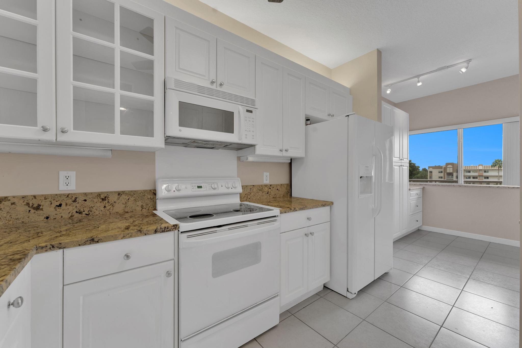 Move-in ready 2 bed, 2 bath condo in highly desirable 55+ gated community of Southampton at Kings Point in Tamarac! Freshly painted with real wood floors, a spacious layout, and enclosed balcony with water views. Features full-size washer/dryer in-unit, impact windows, and elevator access. Immaculate and quiet building with beautifully maintained grounds. Enjoy resort-style living with access to Kings Point’s clubhouse, pools, theater, fitness center, tennis, classes, and free shuttle. Clubhouse deed fully paid! Conveniently located near shopping, dining, and healthcare. Service Pet Allowed and priced to sell fast! Schedule your showing today.