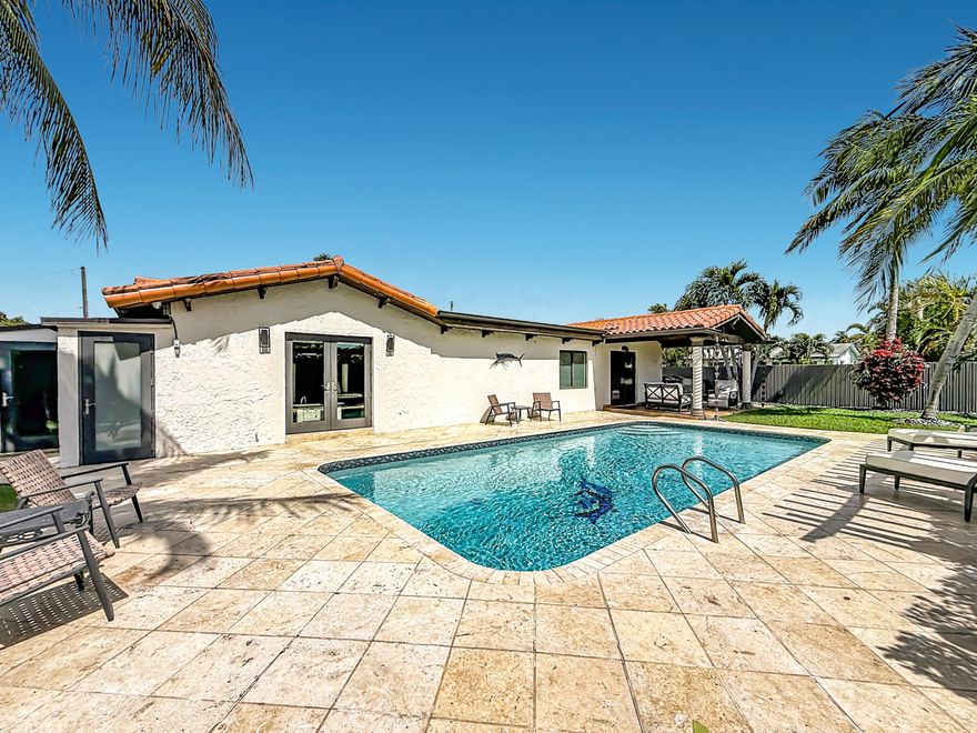 Rare Find Ocean Access Home!  Move right in this elegant, like new, Tuscan-inspired home tucked in a very private waterfront enclave.  Entertaining Paradise!  This 3 bedroom, 3 full bath home is situated on a large corner lot at the end of a canal, the property offers 95 feet of waterfront with a 15K LB hurricane rated boat lift. One fixed bridge via Dania Cutoff Canal.  Spacious primary suite with two large closets, ensuite bath with jacuzzi tub.  Hurricane impact windows and doors, fully updated kitchen and baths.  High end appliances, updated lighting.  Poolside office/storage room, 2 car insulated garage (currently used as a home gym) with A/C, laundry, refrigerator.  Private large heated pool, outdoor entertaining area on both the side and rear of the home. Easy to show! Square footage of home is larger than indicated on tax rolls.