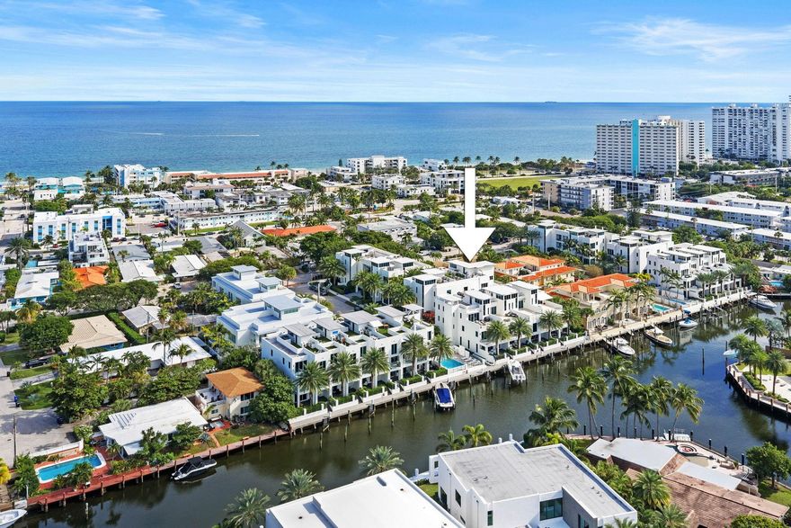 BOAT DOCK INCLUDED with a value of $175K that can be sold to another resident in the community. No fixed bridges. Enjoy the beach and boating lifestyle in this modern masterpiece at Sky 230. Constructed in 2017 this end unit of 3090 sq ft offers 3 interior levels plus a stunning roof top terrace and summer kitchen with distant ocean views.  Along with the 2 car garage the living space is on the ground level and a private rear patio.  The sumptuous master suite encompasses the entire 3rd floor and consists of 2 walk in closets, huge bathroom and spacious bedroom with windows on 3 sides. The unit is equipped with a gas stove and tankless HWH.  There are toto toilets throughout, impact glass, Italian porcelain floors, German cabinetry and an elevator. Walk to the beach, dining and nightlife.