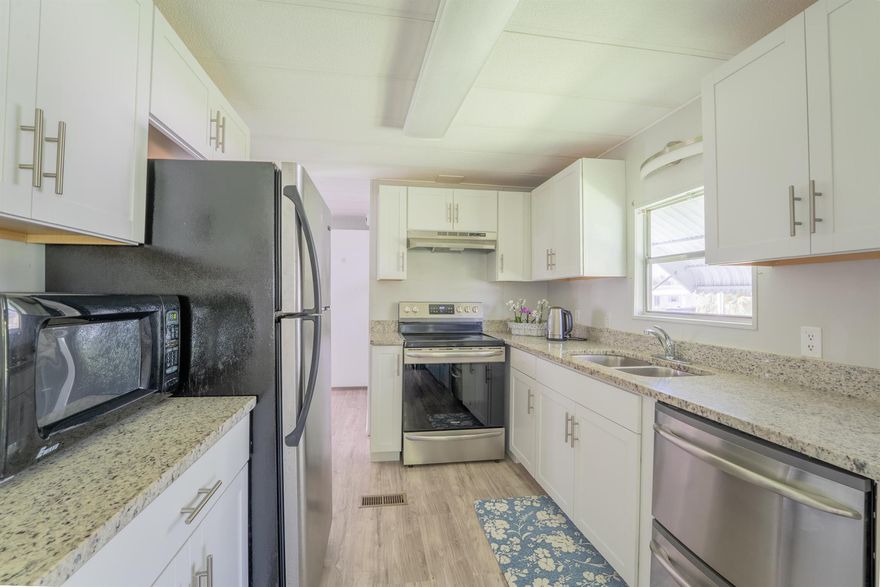 Welcome to 176 W Caribbean--a beautifully maintained 2-bedroom, 2-bath home located in the highly desirable Pet Section of 55+ Spanish Lakes Golf Village. This move-in ready residence features a spacious split-bedroom layout, updated kitchen, gray laminate flooring throughout and a french drain. Enjoy indoor laundry and a large screened-in Florida room perfect for relaxing or entertaining.The land lease includes property taxes, lawn care, trash removal, and access to an impressive array of amenities: golf, pool, pickleball, tennis, bocce, billiards, clubhouse, library, and more. Whether you're looking to stay active or simply unwind by the pool, this vibrant 55+ community offers something for everyone.Future residents must be approved by Spanish Lakes.