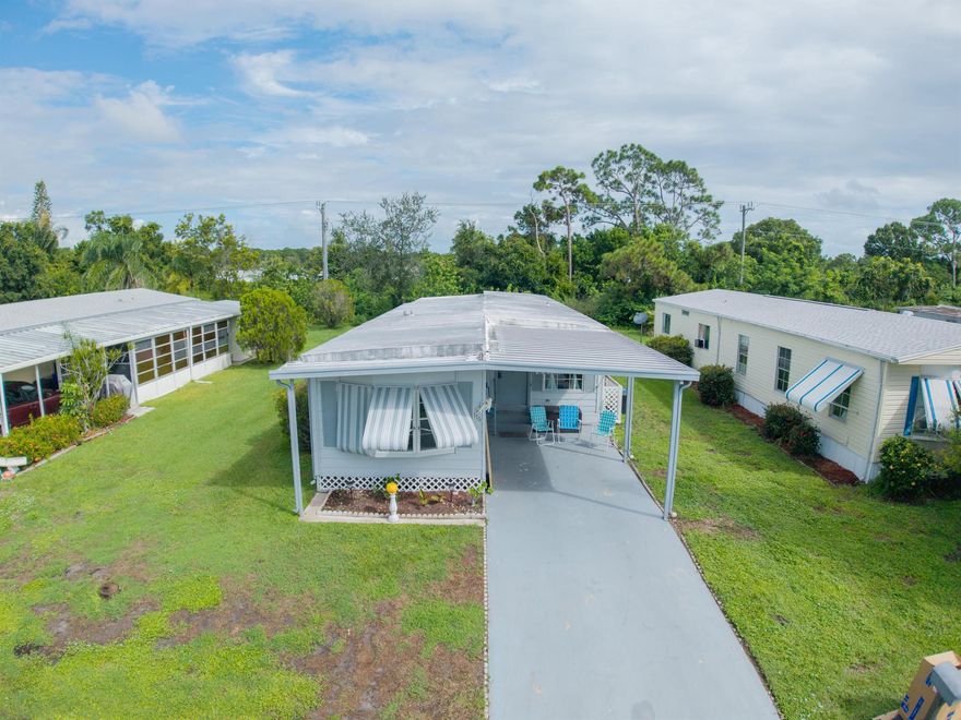 Welcome to 176 W Caribbean--a beautifully maintained 2-bedroom, 2-bath home located in the highly desirable Pet Section of 55+ Spanish Lakes Golf Village. This move-in ready residence features a spacious split-bedroom layout, updated kitchen, gray laminate flooring throughout and a french drain. Enjoy indoor laundry and a large screened-in Florida room perfect for relaxing or entertaining.The land lease includes property taxes, lawn care, trash removal, and access to an impressive array of amenities: golf, pool, pickleball, tennis, bocce, billiards, clubhouse, library, and more. Whether you're looking to stay active or simply unwind by the pool, this vibrant 55+ community offers something for everyone.Future residents must be approved by Spanish Lakes.