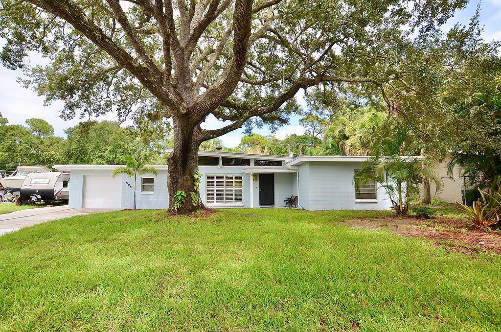 You will fall in LOVE! with this Charming Concrete Block Mid Century Modern home with 2017 Metal Roof, New A/C!. Move in ready. Brand new remodeled kitchen with quartz counters. Remodeled bathrooms.They don't make them like this anymore! Beautiful Wood beam ceilings, Brick Fireplace, Stunning Slate flooring in main areas and Luxury Vinyl Plank in bedrooms with built in closets. Garage is oversized with brand new washer and dryer and lots of storage space. There is a bonus room off the 3rd bedroom that could be used as a office, giant closet, Beautiful A/C'd Florida Room and Covered patio overlook your 11,326sf fenced yard. This is a quiet location that backs up to a preserve on the White City / River Park Border. Also listed for sale or could be rented 6 months for $2600 per month.