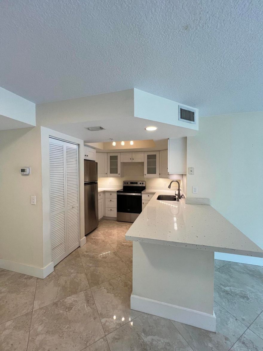 Welcome to resort-style living in Grand Isles Condominium! This fully renovated 2-bedroom, 2-bath condo offers modern living in a prime West Palm Beach location.  Featuring a bright open layout, updated kitchen and bathrooms, and a spacious primary suite with a walk-in closet and private en-suite. The second bedroom also includes its own en-suite—perfect for privacy or guests. Enjoy your private balcony.  Located in a gated, all-ages, pet-friendly community with resort-style amenities including a pool, fitness center, clubhouse, and tennis courts. No assessments for added peace of mind.  Prime location just minutes to I-95, Florida Turnpike, shopping, dining and CACTI Park of the Palm Beaches. Easy to show!
