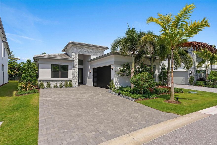 Experience luxury living in the prestigious Lotus Edge community with this exquisite newly built Bermuda Premium model residence offering 4 bedrooms, 3.5 bathrooms, plus a spacious den. This home showcases a bright open-concept layout with soaring ceilings, abundant natural light, and refined custom finishes throughout. The chef's kitchen is thoughtfully designed with upgraded cabinetry, gas appliances, double ovens, and a 5-burner cooktop, seamlessly flowing into expansive living and dining spaces perfect for entertaining and everyday living.  EV charging outlet at garage. Residents enjoy resort-style amenities including a luxurious clubhouse, fitness center, pools, tennis and pickleball courts. Ideally located near upscale shopping, fine dining, Boca Raton beaches, and top-rated schools.