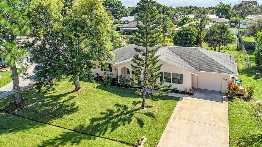 New Listing Alert! Discover this charming three-bedroom single-family home featuring a fence and gated yard, a delightful screened patio, and a variety of fruit trees. The thoughtfully designed split floor plan showcases durable concrete block construction. Step into the eat-in kitchen, equipped with modern stainless steel appliances. Enjoy ample living space, abundant storage options, and the convenience of a one-car garage. Located conveniently near major shopping centers and exceptional schools, this home is just a stone's throw away from vibrant dining and retail options. Additionally, you'll find only one bridge separating you from the pristine beaches of Hutchinson Island. This beautiful property offers an exceptional blend of comfort and affordability. Don't miss out--