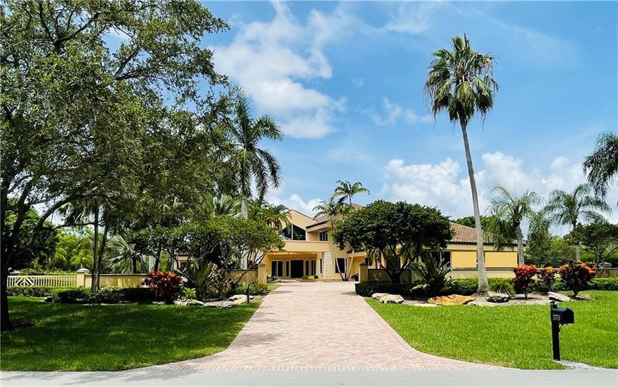 Located in Weston's most prestigious gated community:  Windmill Ranch Estates.  This magnificent  7 bedroom 8 bathroom estate is seated on an exquisite water front 77,161 SqFt lot with amazing views through out. It includes a circular driveway, split plan, movie theater, wet bar area with pool table, elevator.  All bedrooms have their own bathroom and walking closets, spectacular master suite with his and hers sinks and steam sauna.  Office with custom built-in cabinetry, gourmet kitchen with spacious island and stainless steel top of the line appliances.  The patio area is great for entertaining with an oversized pool, spa, and great outdoor kitchen for family and friends to enjoy.  A must see!