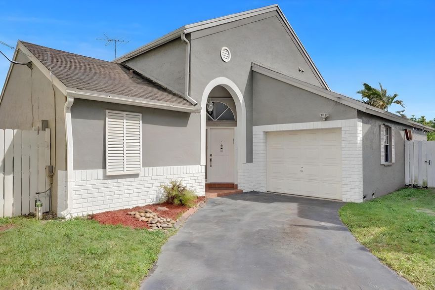 A Beautiful and spacious 3 bedrooms 2 bathrooms home in the peaceful neighborhood of Scarborough in West Davie.  The house features a large kitchen with granite counter-tops and stainless steel appliances.  Laminate floor throughout the house.  Split floor plan with vaulted ceilings.  Very spacious and very bright.  Ring doorbell and fiber optic ready.  The property has been updated with new plumbing throughout the entire home.  Corner house, fully fenced with a large screen patio perfect for entertainment.  A very well maintained community with a community pool and spa, playgrounds, tennis and basketball courts.  Centrally located, easy access to I-595 and other main highways, shopping centers, restaurants, Sawgrass Mills, places of worships and much more.  A+ school zone!!!