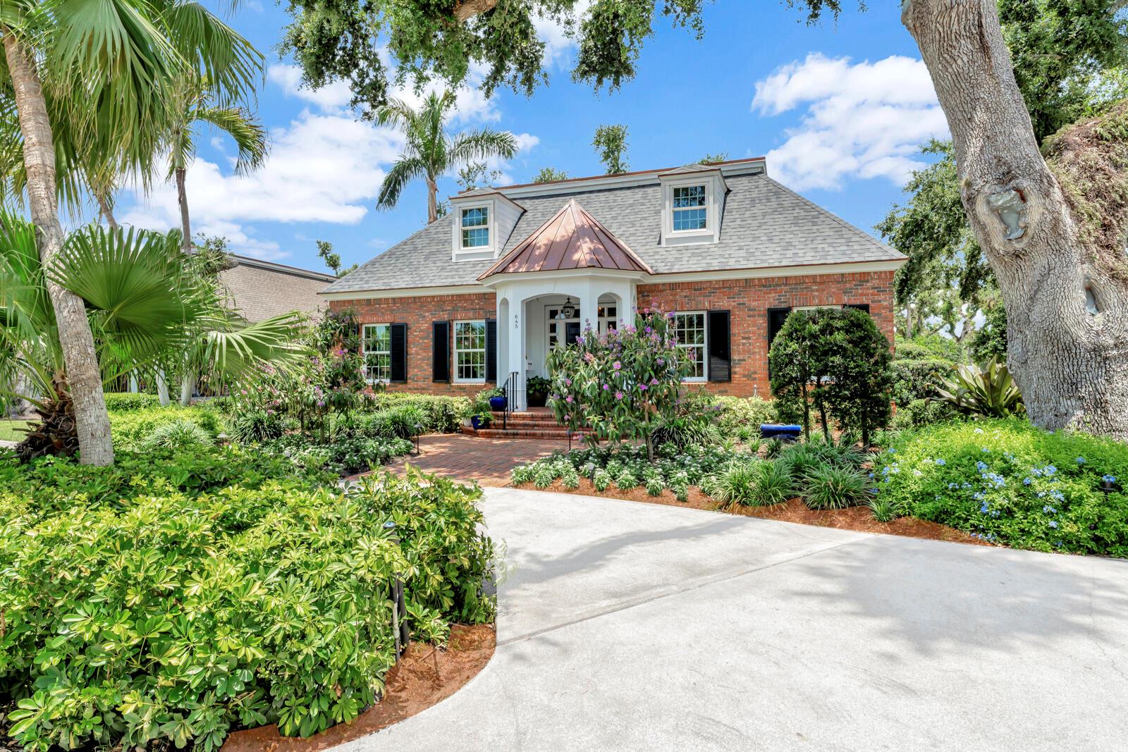 Welcome to Charleston Square, a charming enclave of just six homes nestled beneath majestic oaks, steps from Quail Valley Club. Enter a grand center hall that runs front to back, highlighted by elegant custom coffered ceilings. This timeless brick home features dual owner suites on the first floor, 9' ceilings, and a fireplace. Upstairs, take the elevator to two large guest suites with a shared screened balcony. A 2025 roof, impact glass, Generac generator, and electronic shutters offer peace of mind. Garden terraces, private pool, and detached 2-car garage complete this rare offering.
