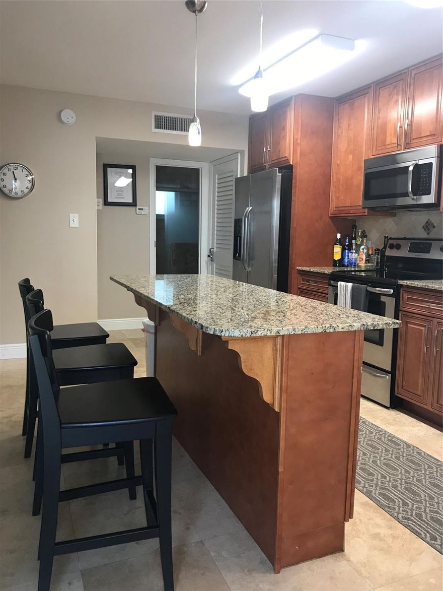 Move-in ready and beautifully maintained, this inviting unit features stainless steel appliances (including a dishwasher), granite countertops, rich wood cabinetry, travertine tile floors, and a sleek walk-in shower. Impact windows and doors provide comfort and peace of mind. Enjoy convenient on-site laundry, a BBQ area, and plenty of off-street parking. Ideally located near beaches, shopping, dining, major highways, and public transportation just minutes to the airport, seaport, and Broward Health Medical Center. Priced to rent quickly schedule your tour today!