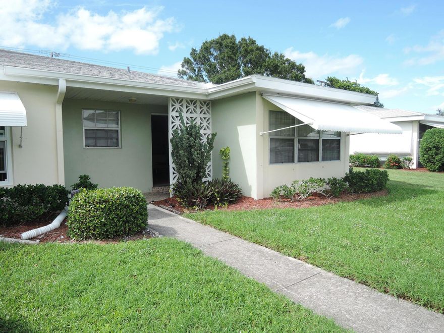 Beautifully maintained end condo in this gated senior complex. The owner had updated the kitchen with a partial wall removal & a butcher block snack bar. Lots of cabinets & drawers for plenty of storage in kitchen. Owner installed a laundry closet w/full size washer/dryer in the dining area. There is still room for a small dining set, or the FL RM could serve as a formal dining room. Tiled floors except in bedrooms, pretty accent walls in living area. Updated vanities in both baths with new tiled floor in guest bath. Master bath has the tub with original tiled walls. Owner installed large open patio at back of condo as a great place to grill out or enjoy nature.