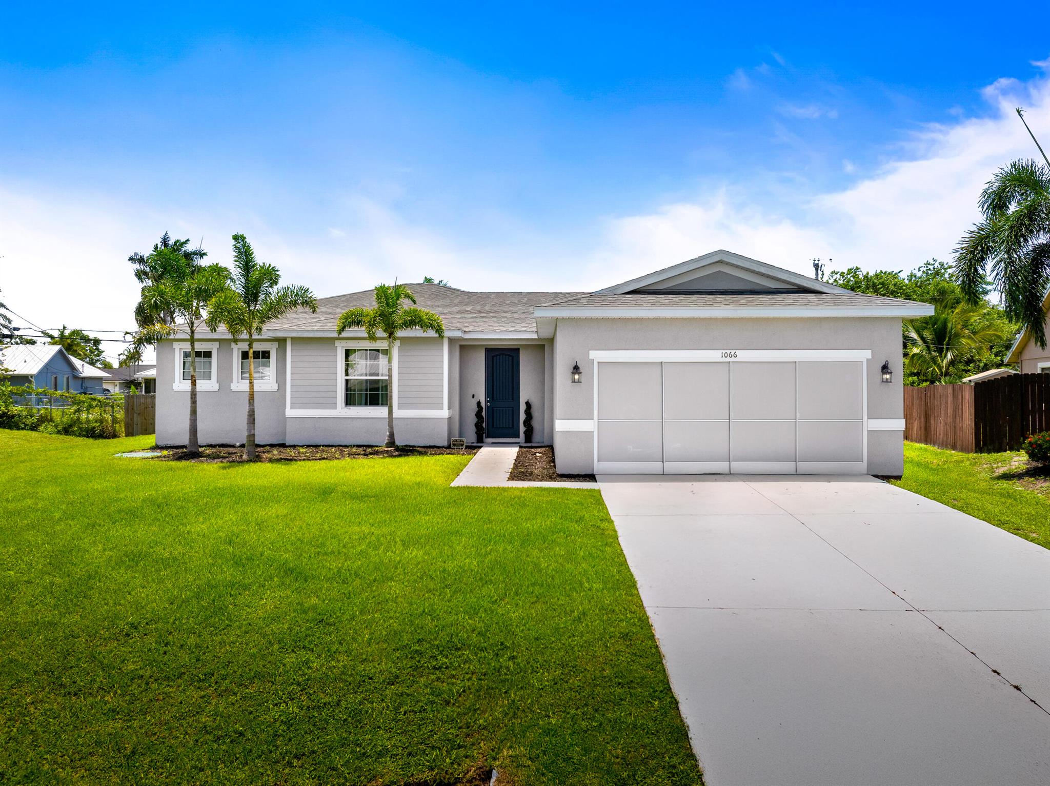 Beautiful 4-bedroom, 2-bathroom home built in 2022 offering 1,775 sq ft of modern living space. This well-maintained property features 9-foot ceilings, granite countertops, and 42-inch cabinets in a spacious, open-concept kitchen. The split floor plan offers privacy, and the primary suite is generously sized. Enjoy outdoor living with a screened-in patio and a private outdoor jacuzzi--perfect for relaxing evenings. Additional upgrades include a Tesla charger and energy-efficient features throughout. Conveniently located near I-95 with easy access to shopping, dining, and entertainment. Move-in ready and packed with upgrades--schedule your tour today!