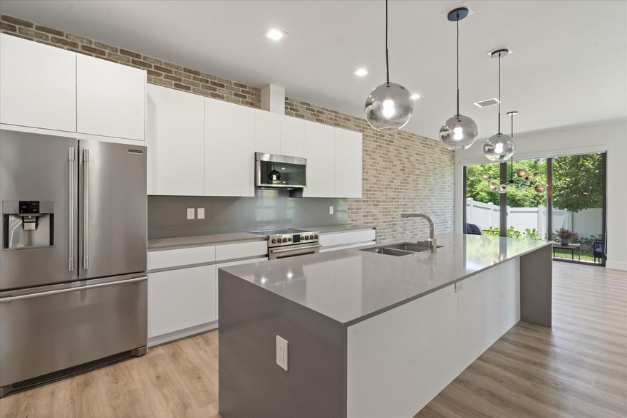 Welcome to Portofino Residences, an exclusive community of just 12 custom-built townhomes built in 2019, located minutes from Las Olas, Downtown, Fort Lauderdale Beach, & FLL Airport. This beautifully updated corner townhome offers 3 bedrooms, 2.5 baths, a spacious 2-car garage w a paver driveway. Designed for comfort & style, modern kitchen w white cabinetry, quartz countertops featuring waterfall edges, & SS appliances—perfect for entertaining or everyday living.  Highlights are a striking brick accent wall, walk-in closets, & second-floor laundry room. The entire home has been freshly painted, giving it a clean, move in ready feel! Step outside to a fully fenced, freshly landscaped yard-ideal for relaxing, pets or play! This is South Florida living at its best-don't miss the opportunity