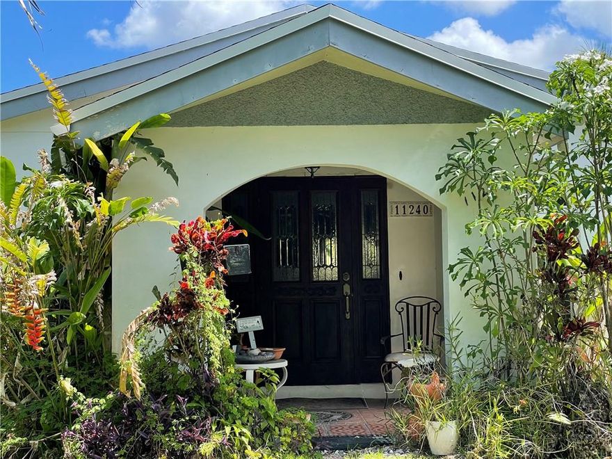 Beautiful family home on a huge lot with numerous fruit bearing trees. New additional square footage to original house adding front room, front porch, den/office, garage and a complete efficiency with bathroom, kitchen and individual A/C unit. House has a total of 4 bedrooms & 3 bathrooms accounting for the efficiency that was added to the house. The original garage was turned into a den/office and a new garage was built and Master Bedroom was expanded with additional square footage at approximately 4,000sqft (square footage to be verified by buyer). Impact windows in master bedroom, second and third bedrooms. The lot has numerous fruit bearing trees. This house has a lot of protentional to become your dream home.SOLD "AS IS"