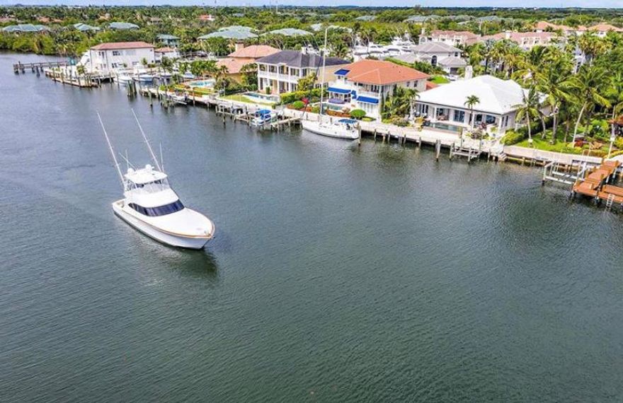 Boater's Dream!!  Direct Intracoastal residence located just south of PGA Blvd in a no wake zone with dockage for up to a 70' boat.  Open floor plan home with a rear eastern exposure on a quiet cul de sac street in a desirable, gated enclave.  Impeccable property with spectacular views and ocean access only minutes away - no fixed bridges!  Breathtaking kitchen and a Master Suite with spectacular views of the waterway, custom closets, an elegant master bath and direct access to the pool/spa area.  Home highlights include hurricane impact protection throughout, whole-house generator, tankless hot water heater, and motorized outdoor awnings.  An inviting outdoor living area with an infinity edge pool, bar and built-in grill celebrate breathtaking views of the waterway and passing yachts.