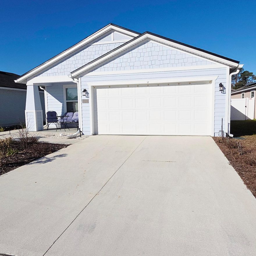 Welcome home to this tastefully upgraded St. George model home in Ravenswood Villages. This new community is located only minutes from historic downtown St. Augustine and area beaches. This 4 bed 2 bath smart home, completed in 2024, has an open floor plan that's great for entertaining friends and family. The back yard is set up for entertaining also with white privacy fencing, a stone paver patio, bbq grill and fire pit. The owner has made many upgrades with quality materials to make this not only an easy home to maintain, but a beautiful home as well. All kitchen and bath countertops are curava sea glass, all flooring is LVP, the interior has been completely repainted, glass shower doors and lighted vanity mirrors installed in both bathrooms, and the 2 car garage floor has been coated by shark coatings. There is also heavy duty shelving and six 8ft led lights installed. Come take a look at this new upgraded home today.