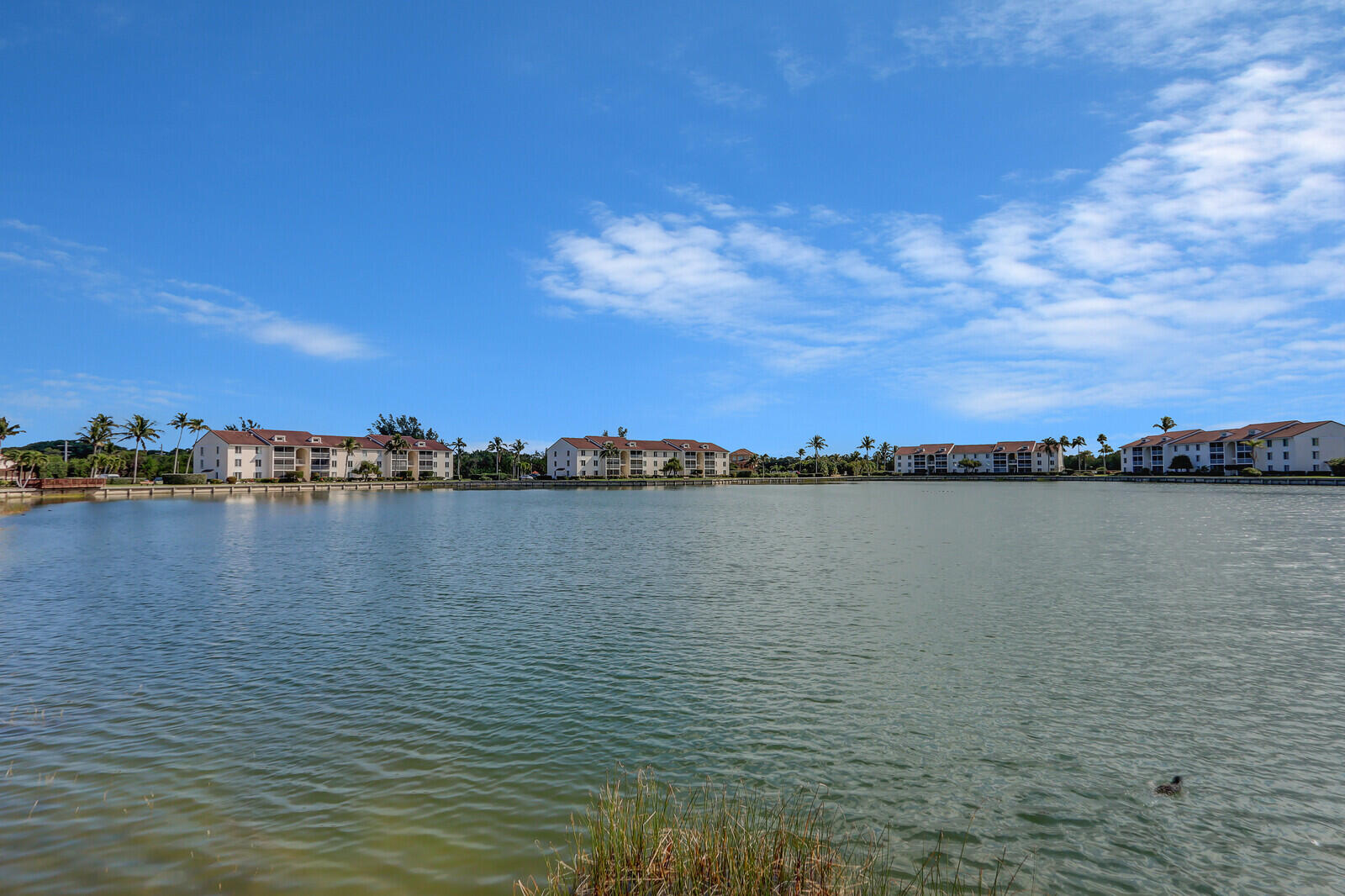 **DIRECTLY ACROSS THE STREET FROM THE OCEAN** is this GATED, fully furnished, wonderful, clean, turnkey, second floor 2/2 condo (no elevator) with screened in private lanai. Amenities include a stocked 7 acre fresh water lake for fishing, two hard surface lighted tennis courts, bocce, shuffleboard, heated swimming pool, adjacent spa and community clubhouse. In the heart of the Barrier Island this location offers fabulous restaurants, shopping, and beautiful beaches! The active social calendar boasts activities for everyone.