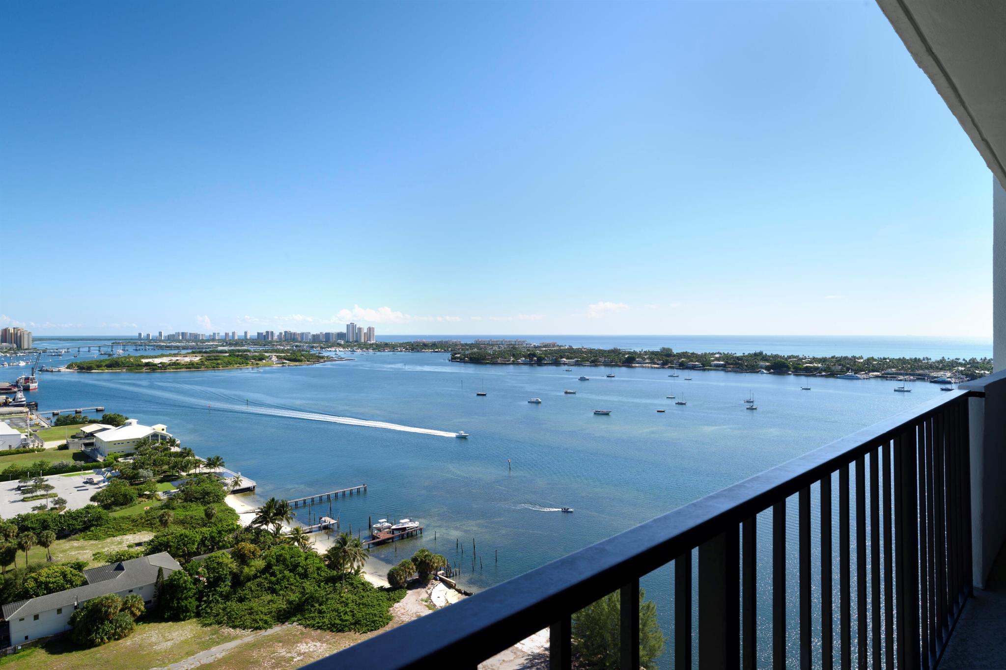 Enjoy expansive Intracoastal and Ocean views from this highly sought after 3 bedroom floor plan located in The Palm Beach House. Move in ready condition with all rooms freshly painted, impact windows and sliding glass doors, fabulous updated kitchen with separate bar area and full size washer and dryer in unit. Oversized balcony with breathtaking water views. Complex offers resort style living with gorgeous pool on the Intracoastal waterway, private sand beach to easily launch your paddle board, tennis courts, exercise room and many other amenities. Secure, manned entry gate and lobby. Cable, internet, and water included. One pet welcome! Perfect location close to the Island, Downtown WPB and the Palm Beach Airport.