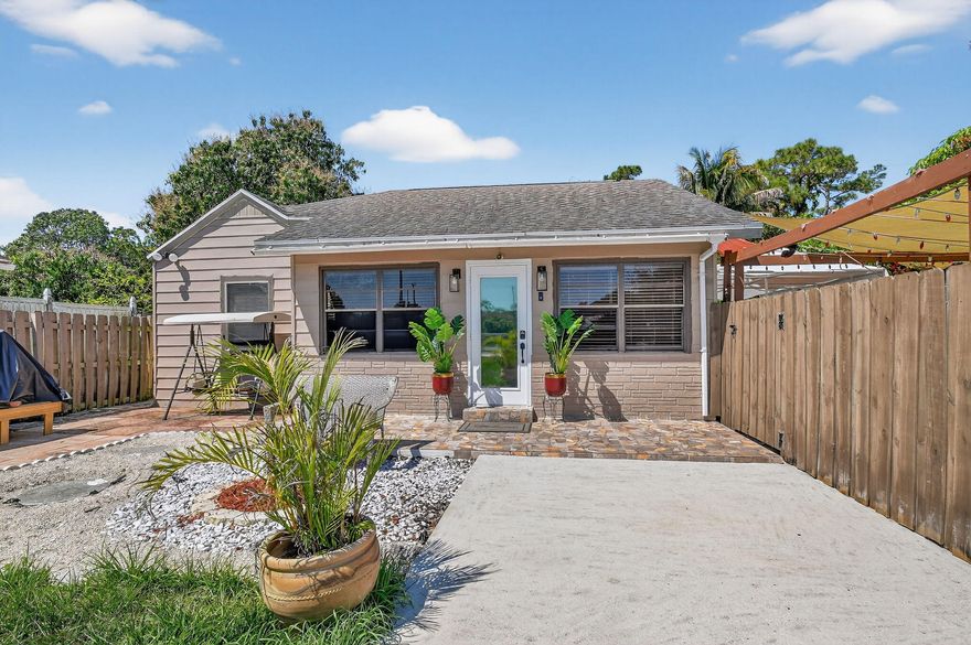 Beautifully updated 3 bedroom, 3 bathroom single family home.  oOffers an open-concept floor plan with porcelain tile flooring throughout the main living areas, neutral paint, and abundant natural light. Kitchen features white cabinetry, granite countertops, stainless steel LG appliances, and a breakfast bar. The primary suite includes a spa-like bathroom with a frameless glass walk-in shower, modern fixtures, and LED mirror. This versatile property includes a separate efficiency with its own private entrance — an excellent income-producing opportunity for rental income, guests, or multigenerational living. This house is move-in ready, features a HUGH front yard with parking for up 8 vehicles, lots of room for entertainment and remote controld gate. Schedule your private tour today!