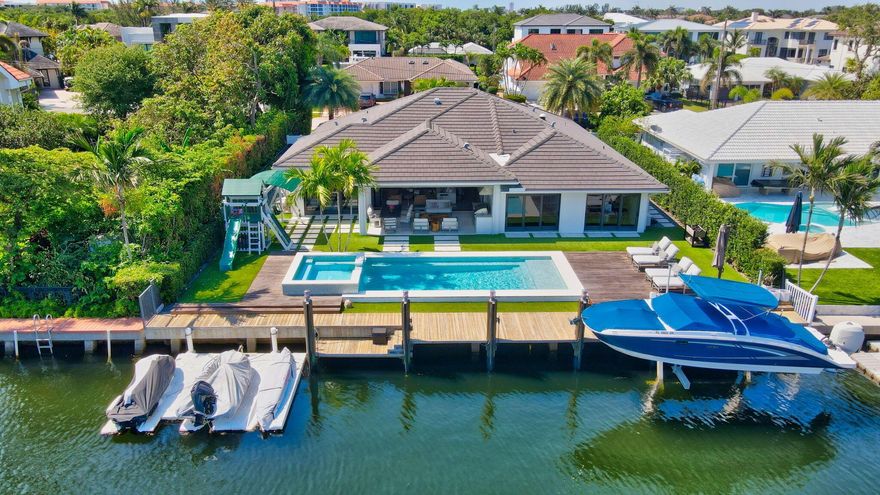 Spectacular waterfront home! Prime Intracoastal location less than 1 mile walk to the beach! Desirable Lake Rogers neighborhood is quiet yet close to the action of downtown Boca/Delray (5-10 min) and Ft.Laud/WPB/Miami (30-45 min). This home was completely renovated/expanded in 2016 w/ the finest of touches. Exterior Features: Large yard, landscape lighting (front/back), clean landscape, Turf, 10,000 lb Boat Lift, 3-Position Floating Dock, DCS Summer Kitchen with Refrigerator/Ice Maker/Grill, Full Impact Windows/Doors, Whole House Generator, Natural Gas, Saltwater/Heated Pool with WiFi controls, Circular Driveway, Roof (2016), Electric and Plumbing (2016), tankless water heater (2016).
