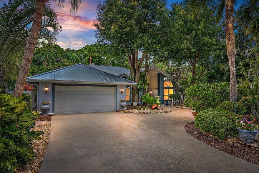 New roof and new kitchen! This 4-bedroom, 2.5-bath home features a new metal roof and a fully redesigned new kitchen, offering long-term value and modern style. The new roof provides peace of mind, while the new kitchen is ideal for entertaining. Situated on the largest lot in the community, with lush tropical landscaping, the home offers vaulted ceilings, skylights and tile flooring throughout. The main-level primary suite includes garden views, French doors, walk-in closet, and spa-style bath. Additional highlights include impact windows and doors, loft, flex spaces, epoxy garage floors, and access to Mystic Cove's private dock.