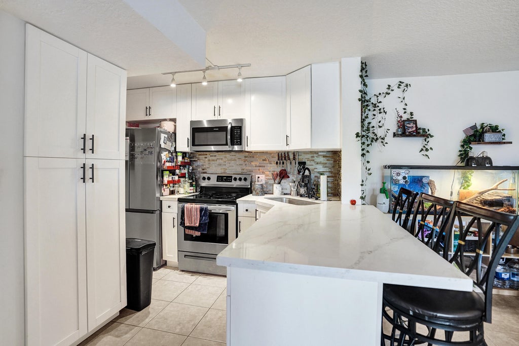 Photo of 629 Sea Pine Way #A1, Greenacres, FL 33415 (MLS # B26080266)