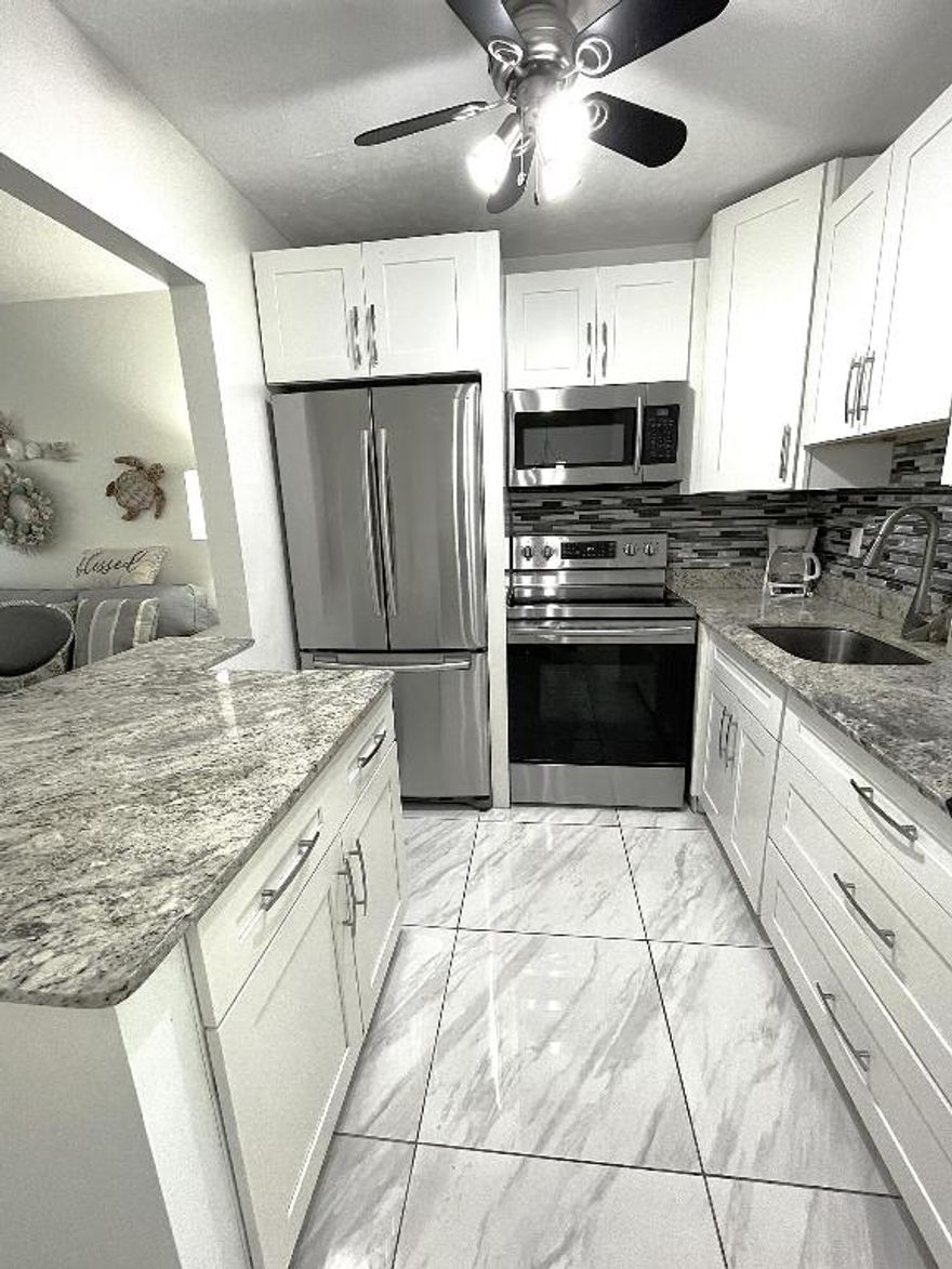 Come fall in love with this rarely available one bedroom, waterfront condo nestled in a private, gated community in East Boynton Beach. Sleek, seaside kitchen with granite counters, stainless steel appliances, and a built-in snack bar. The kitchen opens to the living area for today's modern lifestyle. Romantic master suite with sparkling water views. Relax and enjoy cool breezes on your screened-in patio while watching the boats go by. Sterling Village offers a dynamic 55+ lifestyle with resort style amenities, a full calendar of social activities, and a variety of clubs - the perfect blend of relaxation and recreation. Fantastic location - just minutes to shopping, dining, and pristine beaches. Make this coastal chic oasis your home! Hurricane shutters. Laundry in the unit allowed.