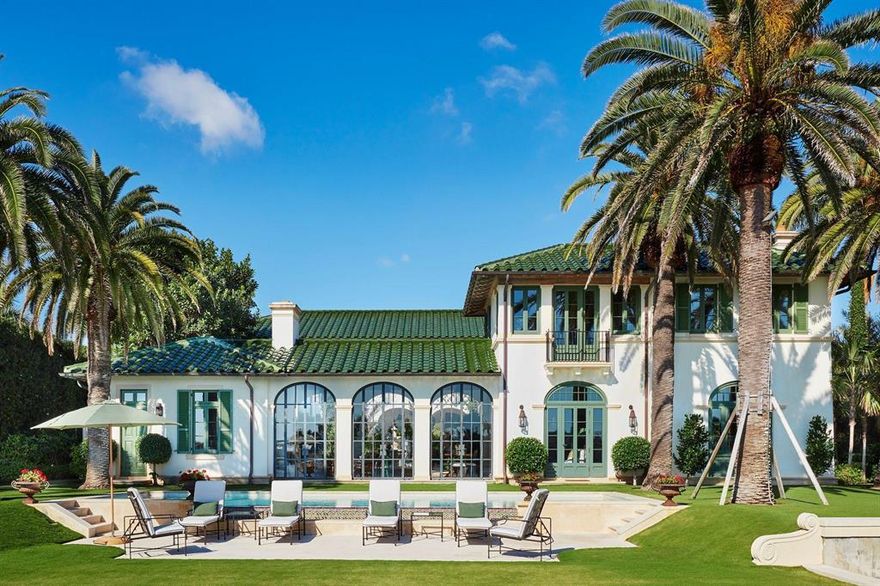 This direct waterfront villa known as Il Cortile reflects the classic and refined Mediterranean style of Palm Beach. From the moment you enter, the villa romances your senses. Located on the east side of Everglades Island, the award-winning estate was designed by architects Fairfax & Sammons and is on the market for the first time.   With approximately 7,500 +/- sq. ft. of total indoor/outdoor living, the villa surrounds an exquisite 900 +/-sq. ft. central courtyard that is framed by loggias and graced with a charming fountain and water views which provide the perfect backdrop for gracious entertaining.  Beautiful archways and balconies overlook the courtyard offering sparkling water views. Two grand trees on each side of a brick drive welcome guests. Every thoughtful element used contributes to an Old World feel, from the stucco faÃ§ade and the distinctive glazed green barrel-tiled roof to the dramatic arched doors, casement windows with classic shutters, coffered and vaulted ceilings, limed cypress rafters, and colorful antique European tile. The kitchen features a center island, high end appliances, a hand-carved stone hood and views of Palm Beach and Tarpon Island; an elegant great room includes space for both comfortable living and formal dining; a warm wood paneled study or library is a peaceful retreat; the elegant  master suite includes a sitting-room with serene views of the grounds; four timeless guest bedrooms have ceiling fans, handsome wood floors and ensuite baths with French and Belgian encaustic tile; the powder room is also detailed with eye-catching Portuguese tile.

The villa's ambiance is enhanced by tasteful landscaping, large shade trees, thriving bougainvillea and other lush tropical foliage.  The pool is located on the expansive lawn by the lake which provides gentle breezes and lovely water views.  A private dock with boat lift facilitates boating and water activities on Lake Worth.