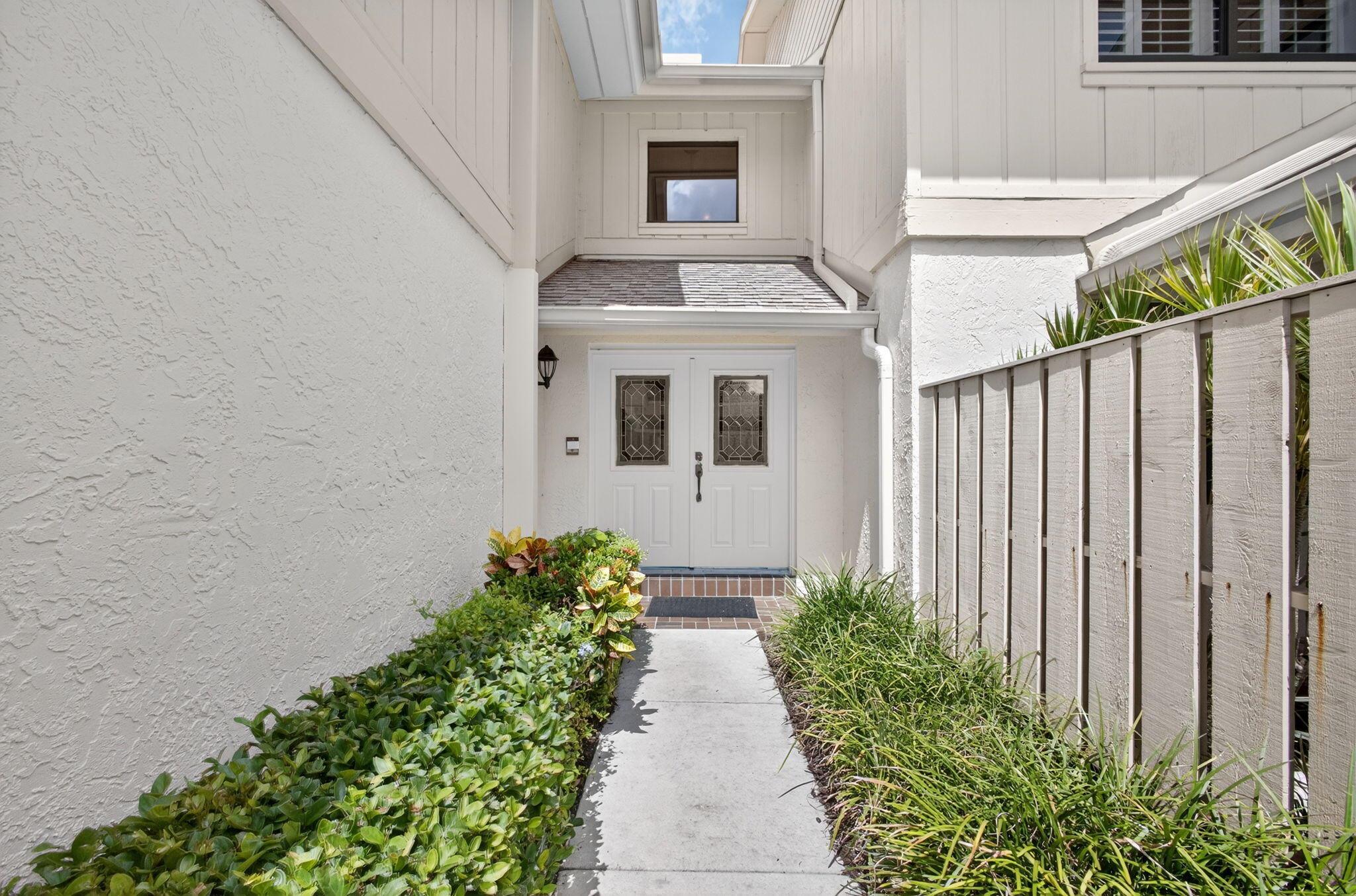 Welcome to this beautifully updated 2-bedroom condo with a versatile den, perfectly designed to serve as a third bedroom, private home office, or cozy reading nook. Nestled within the prestigious Waterbend community of Jonathan's Landing, this home offers both comfort and style in one of Jupiter's most desirable locations. From the moment you step inside, you'll appreciate the fresh paint, new carpet, and open floor plan that make this condo move-in ready. Cathedral ceilings invite natural light to fill the living space, creating a bright and airy atmosphere. Enjoy peaceful mornings and relaxed evenings on your screened-in porch, where sweeping views of the 10th fairway provide the perfect backdrop for entertaining or unwinding after a long day. This residence also (see more)...