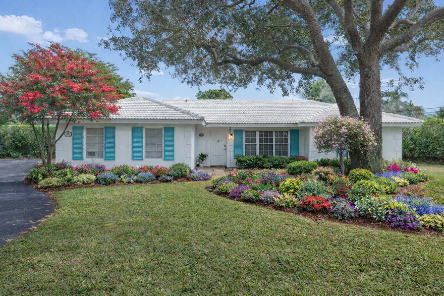 Nestled on a quiet cul-de-sac in the highly coveted Lake Ida neighborhood, this exceptional residence offers a rare combination of impressive interior scale, an expansive oversized homesite, and an unbeatable location just moments from the heart of Delray Beach. Set on beautifully open grounds with sprawling green space stretching across the front, side, and backyard, the property provides an extraordinary sense of space and privacy yet remains just a golf cart or bike ride from fine dining, boutique shopping, pristine beaches, and the vibrant energy of Atlantic Avenue.
Positioned thoughtfully off the street, the home is approached by a private walkway that leads across an expansive front lawn shaded by a mature tree, creating a welcoming first impression and a true sense of retreat. Inside, a charming foyer with beadboard walls offers a warm and functional transition into the home, with convenient access from both the front entry and garage.
The home's remarkable size is enhanced by a unique three-way split floor plan that provides privacy, flexibility, and versatility for a variety of lifestyles. Multiple living areas flow seamlessly together while maintaining distinct zones for everyday living and entertaining. Updated wood flooring carries throughout the main spaces, adding warmth and continuity.
At the heart of the home, the kitchen has been thoughtfully renovated by owners with a true passion for cooking. Designed to balance effortless entertaining with exceptional functionality, it features an expansive granite island, custom cabinetry, quartz perimeter countertops, and a stainless steel Viking appliance suite including a gas range with pot filler, double ovens, and a microwave. A separate prep and cleanup station with an additional sink and dishwasher enhances efficiency, while a large custom pantry provides abundant storage. New lighting and updated plumbing were incorporated during the renovation, and a pass-through window connects directly to the outdoor patio, making indoor-outdoor hosting seamless.
The open great room and dining area flow naturally from the kitchen, while the adjacent family room accented by decorative faux wood ceiling beams and French doors opens to the charming Chicago brick patio. Custom built-ins between the kitchen and family room add both character and storage.
A standout feature of the home is the expansive bonus great room at the rear, rich with architectural character. Vaulted wood-beam ceilings and a dramatic floor-to-ceiling stone fireplace anchor the space, complemented by built-in shelving, cabinetry, and a built-in bar area that elevates its entertaining potential. A wall of sliding glass doors opens fully to the Chicago brick patio, creating a seamless indoor-outdoor experience. With its generous proportions and new lighting, this retreat offers incredible flexibility as a media room, lounge, game room, creative studio, or future reimagined space.
The bedroom layout further enhances the home's versatility. The primary suite is privately positioned at the front of the home, creating a peaceful retreat. Bedrooms two and three occupy their own wing off the family room and share a renovated bath. A separate hallway door leads to a private guest or in-law wing featuring a fourth bedroom and a renovated cabana bath, ideal for visitors or multigenerational living.
While meaningful improvements have already been completed including the beautifully renovated kitchen and select bathrooms there remains opportunity for a new owner to further update and personalize the home to their vision. With its generous footprint and solid foundation, the property presents an exceptional canvas for additional enhancements over time.
Outdoors, the scale of the lot truly distinguishes this property. The oversized homesite offers sweeping green space across every side of the residence, creating a rare sense of openness so close to downtown and the coast. A fully fenced yard framed by mature hedging provides privacy and lush surroundings, while the Chicago brick patio and large screened enclosed terrace, complete with a television and kitchen pass-through, invite year-round enjoyment. The generous lot easily accommodates the vision of a future pool, and the expansive front lawn offers additional flexibility for recreation, play, or enhanced landscaping.
Functional features complement the home's size and character, including a remotely controlled electronic smart lock at the front entry, a buried 500-gallon propane tank, two A/C systems with a dedicated unit for the bonus wing, and an oversized garage. The roof was replaced in 2010, and storm protection includes impact-rated glass at the kitchen pass-through and adjacent windows, select impact-protected bedroom windows, and accordion shutters and removable panels for additional openings.
Homes of this magnitude on oversized lots within Lake Ida, just minutes from downtown, the beach, and coastal dining, are a rare offering. The combination of generous interior living space, sprawling outdoor grounds with room to expand, and an unparalleled location delivers an exceptional opportunity to experience the very best of the Delray Beach lifestyle, with the added potential to continue elevating and customizing the home for years to come.