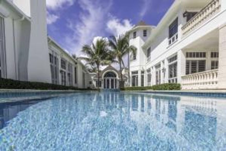 Extremely rare opportunity in the Estate Section of Delray Beach. This oceanfront residence adorns the Estate Section of Delray Beach's Coastline. The completely gated and private estate is nestled off A1A just south of Atlantic Avenue's shops and restaurants and an easy and scenic drive to Palm Beach and Boca Raton. With 100 feet of direct ocean frontage and over 408 feet of depth, the nearly one acre parcel is the perfect setting for this resort-style residence boasting over 12,000 square feet. The private gated main entry and decorative motorcourt lead to the majestic estate and manicured grounds. A Coquina stone arched entryway complete with iron gate and custom wood and glass door unveil the opulent living room with cathedral wood beamed ceilings; stone columns, millwork and fireplace