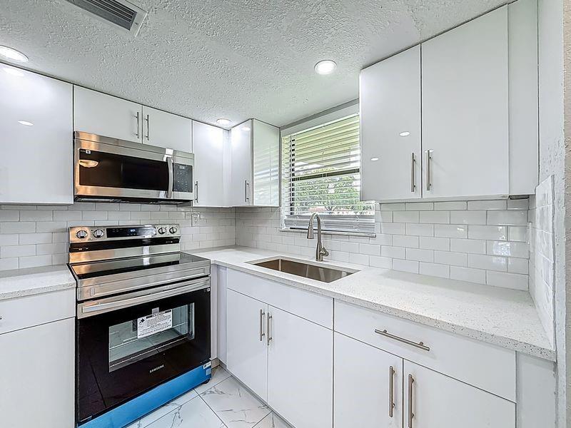 BEAUTIFULLY UPDATED 2/2 1ST FLOOR CONDO. NEW TILE FLOORS, STAINLESS STEEL APPLIANCES, QUARTZ COUNTERTOPS AND MORE. IN-UNIT WASHER DRYER, RAINFALL SHOWER HEAD, LOCATED IN THE HEART OF TAMARAC MINUTES FROM THE TURNPIKE AND SHOPPING. 10 MINUTES TO I-95, AND SAWGRASS MILLS MALL. PERFECT FOR INVESTORS CAN BE LEASED IMMEDIATELY. EASY TO SHOW ON LOCKBOX. TEXT L.A. FOR FAST ACCESS