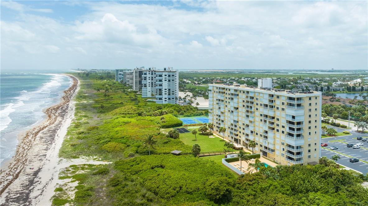 Spectacular Oceanfront Corner Unit with Wraparound Balcony overlooking the Atlantic Ocean. This corner 2 Bed/2 Bath unit boasts an abundance of natural light with two side windows (impact glass) and north side sliding glass doors. The Kitchen has GE Slate Appliances (2022), granite countertops and white beadboard cabinets. Tile plank flooring throughout creates a seamless expansive space. Updated Baths with new vanities and showers. Accordion Hurricane Shutters on all openings.